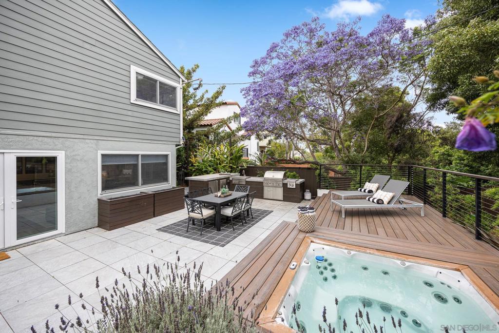This Loma Portal gem sits steps from charming Plumosa Park and lives far larger than it looks. The upstairs level functions like a single story: an open kitchen, dining, and living room flows together, joined by a serene primary suite with a renovated bath and additional 2 more spacious bedrooms and 1 full bath. Downstairs expands the footprint with two additional bedrooms, a full bath, and an oversized living room each with private entrances, perfect for multigenerational living, guest quarters, a home office, or recreation space. A massive basement adds even more possibilities for storage, workshop, gym, or future customization. Throughout the home you’ll find original hardwood floors, generous closets, quality finishes, and large picture windows that flood the spaces with natural light. Paid-off solar boosts efficiency and long-term value. The downstairs living room opens to a private backyard retreat with mature fruit trees, expansive decks, a full outdoor kitchen, built-in spa, and an elegant gas fire table. Ideal for everyday living and effortless entertaining. This home sits at the heart of the neighborhood: enjoy the Halloween buzz, watch SeaWorld’s fireworks flicker across the sky, and delight in an evening neighborhood stroll amid magical holiday luminaries. Rich in character and designed for real-life flexibility 3 bed/2 bath upstairs, 2 bed/1 bath downstairs. This is quintessential Loma Portal. Come see how big it lives!