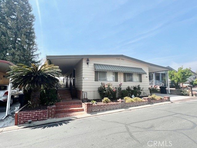 What a Deal!!! Welcome to Valencia Lea, Highland’s premier +55 community! This 2/2 1973 Fleetwood Suncrest 1440sqft home has great curb appeal, brick retaining walls and steps with mature palm and roses, an extra-large front porch with new outdoor carpet and a bonus brick seating area! This 2-bedroom, 2 bath home features new interior paint and new carpet. The large open living and dining areas have plenty of windows, letting in tons of natural light, and built-in dining room cabinets to display all your china. The open kitchen features upgraded solid oak cabinetry, new dishwasher, includes gas cook top and fridge! Just off the kitchen is a family room with slider to the front porch, perfect for informal living. The guest bedroom has a large closet and nearby guest bathroom features tub shower combo. The large primary bedroom has a huge walk-in closet and attached spacious bathroom with glass enclosed low-threshold shower. The full-length carport includes storage shed. Don’t delay in taking a tour!