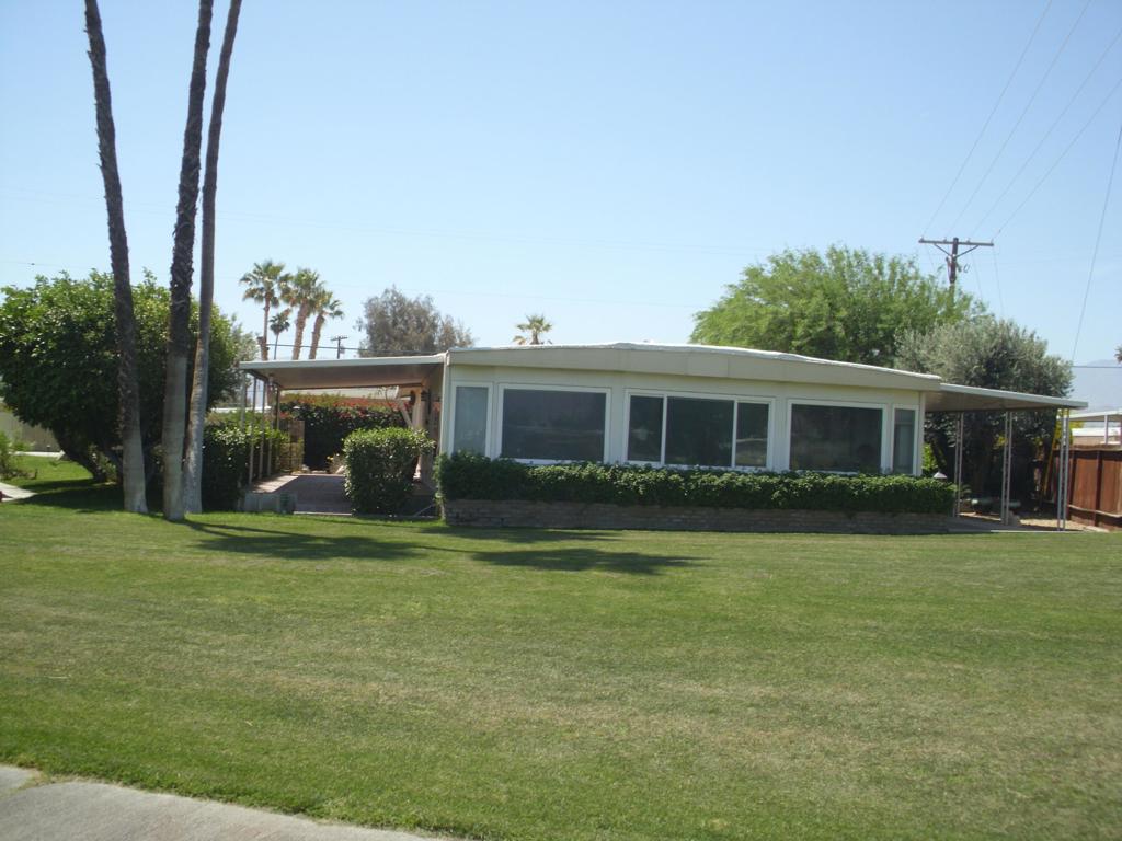 This 1680 sq ft triple wide manufactured home is located on the 3rd hole of the par 3 course. Beautiful Golf course and Mountain views. End to end laminate floors. Huge 12,632 sq ft lot with circular driveway that can be accessed from two streets. oversize 2 car detached garage & golf cart storage.Sold turnkey furnished. Tri palms is an active 55+ community with many activities. Low HOA Fees allowing all the golf 2 owners on title can play, Club House, restaurant, bar, 2 pools, and hot tubs, tennis/pickleball courts, shuffle ball courts. Close to Costco, Sam's Club, Walmart, Lowes, Home Depot, theaters, and may fine restaurants,