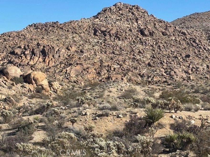 Discover your desert oasis! This 3.15-acre lot is perfectly situated just 5 minutes from the entrance of Joshua Tree National Park, offering unmatched access to hiking, climbing, and breathtaking views.Scenic boulders that add character and charm,ready-to-build site for your dream home or retreat,ultimate privacy while still close to town amenities,ideal for nature lovers, artists, and adventurers.Imagine waking up surrounded by iconic and majestic rock formations, then spending your days exploring the park or relaxing in your own private sanctuary.This rare opportunity combines convenience, natural beauty, and tranquility in one of California’s most inspiring landscapes.
