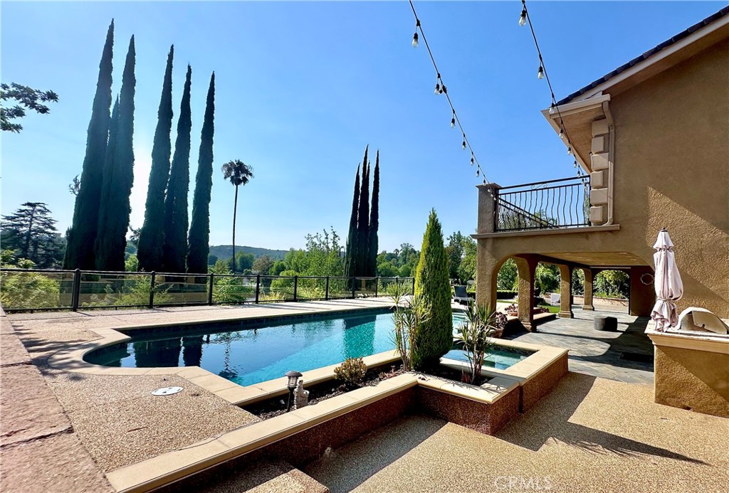 Experience elevated California living in this beautifully upgraded two-story home, tucked away on a peaceful cul-de-sac in one of Woodland Hills’ most desirable neighborhoods. Just minutes from Calabasas Commons, Hidden Hills, and premier shopping and dining, this residence perfectly blends privacy, luxury, and convenience. This 4-bedroom, 3.5-bathroom home spans 2,653 square feet and includes a dedicated private office—ideal for remote work or creative pursuits. Sustainability meets style with a fully owned Tesla solar power system and a Tesla charger, providing energy efficiency and eco-conscious living. A free-flowing open floor plan seamlessly connects the living, dining, and outdoor spaces, enhancing both everyday comfort and effortless entertaining. The backyard is an entertainer’s dream featuring a sparkling saltwater pool, gas-heated for year-round enjoyment, a spa/jacuzzi with remote control, multiple pool light colors, and backyard lighting to create the perfect evening ambiance. A portable fire pit is perfect for cozy nights under the stars, and professional gardening and pool service are included for effortless maintenance. Smart and secure living includes security cameras, Nest-controlled dual air-conditioning units, and a fully wired home with Ethernet connections and Wi-Fi boosters throughout. Inside, you’ll find two fireplaces, high-speed internet, and a thoughtfully designed layout that balances comfort and function. The primary suite offers a true retreat with its own fireplace, a spacious walk-in closet, and serene hillside views. Step onto the oversized balcony to enjoy the scenery or take advantage of the long driveway with parking for up to six cars. Located in an excellent school district, this home offers the perfect combination of privacy, luxury, and convenience. Whether hosting friends, working from home, or relaxing poolside, this Woodland Hills gem delivers the ultimate California lifestyle. Schedule your private tour today.