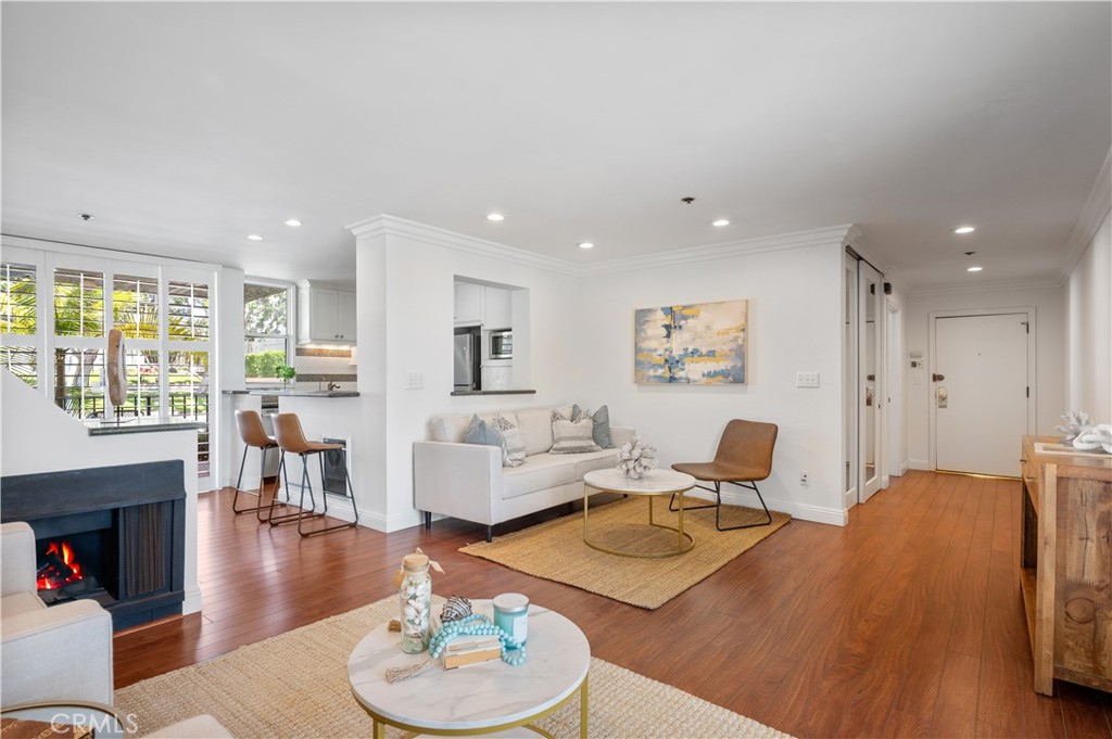 Experience oceanfront living in this beautifully updated single-level condo, perfectly positioned on The Esplanade with breathtaking coastline views from Palos Verdes to Malibu. Two patios—including a west-facing deck—set the scene for your morning coffee or sunset glass of wine overlooking the Pacific.
Step inside to a bright, open floor plan where wide-plank floors, plantation shutters, recessed lighting, and fresh coastal tones create an inviting, airy feel. The living room, complete with a cozy gas fireplace, opens directly to the deck and offers partial ocean views. The remodeled kitchen is thoughtfully designed with stone countertops, white cabinetry, a tile backsplash, and stainless steel appliances. The dining area features built-ins, a buffet, and a wine fridge—perfect for easy entertaining.
The spacious primary suite offers dual closets and an ensuite bath, while the secondary bedroom is filled with natural light and access to the second bathroom. Additional highlights include ample closet space, in-unit laundry, and beautiful floors throughout in the main areas with plush carpet in the bedrooms.
This secure building offers two side-by-side parking spaces, bike storage, a community terrace overlooking the ocean, and direct, secured access to the beach.
All of this and only steps to the beach, the Redondo Beach Farmers Market, the Pier, parks, restaurants, shops and Riviera Village.
To live, live by the sea!