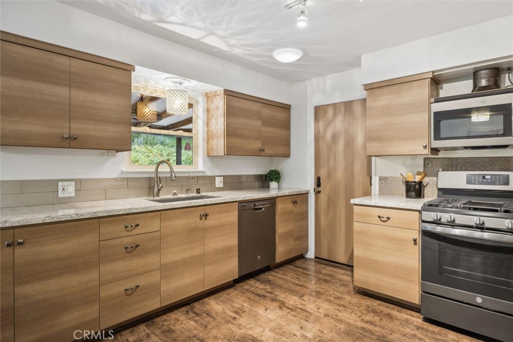 Welcome to this versatile and highly sought-after property, where single-level living meets limitless potential! Nestled on a sizable lot, this home offers two distinct living levels, each bringing its own unique charm. On the main level, you'll find a generous 3-bedroom, 2-bathroom floor plan featuring a contemporary layout, an updated kitchen, and a primary bathroom, all complemented by the convenience of an attached two-car garage. Embrace the ease of ranch-style living, enhanced by energy-efficient solar panels that help reduce your costs.
Venture beneath the main living area, where a unique, unpermitted one-bedroom living space awaits. This inviting area includes its very own full kitchen and bathroom, providing exceptional flexibility for multi-generational families, guests, or rental opportunities. With approximately 500 sq. ft., the lower level enjoys a private entrance, ensuring separation and privacy from the main home.
The expansive lot is a dream come true, offering plenty of outdoor space for gardening, relaxation, or hosting gatherings. Multiple access points allow for ample RV parking and additional storage, with the possibility of future expansion. This large lot holds incredible potential for adding another unit, making it a golden opportunity for savvy investors.
This property is not just a place to live; it’s a canvas for your future dreams—whether that means having extra space, ensuring privacy, or room to grow. Come explore the countless possibilities this unique home has to offer!
