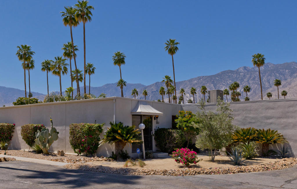 This thoughtfully updated mid-century residence in Garden Villas East was designed by Sherwin L. Barton in 1966. Renovated in 2021 with quartz countertops, stainless-steel appliances, stylish tilework, and a refined mid-century palette. A new HVAC system was added in 2023, and in 2025 the interior--including ceilings--was freshly repainted and all windows and sliding doors replaced with energy-efficient dual-pane vinyl units. The community is also upgrading systems to support solar power. Lush landscaping, two pools, and covered parking next to the unit complete this prime South Palm Springs location.