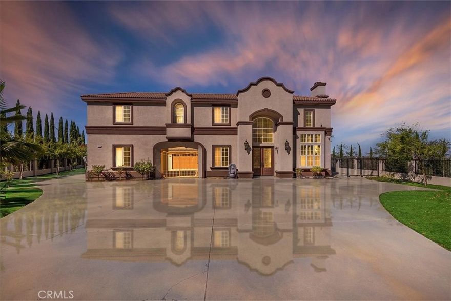 Welcome to 39292 Butterfly Drive, a custom estate perched on nearly 5 acres in the prestigious gated community of Wildwood Highlands. Nestled near Wildwood State Park and just minutes from Oak Glen’s wineries and apple orchards, this home combines timeless elegance with breathtaking surroundings. A grand porte cochere and double-door entry set the stage for the dramatic foyer, complete with soaring ceilings and a dazzling crystal chandelier. Real wood floors flow throughout the main level, where you’ll find an office, 1/2 bath, convenient laundry room with sink, and a detached guest room with its own private full bath, ideal for extended family, guests, or future ADU conversion. Upstairs, discover 4 bedrooms and 3 bathrooms, including the luxurious primary suite, a retreat featuring a private sitting area with fireplace, spa-like bath with soaking tub and glass shower, and an expansive deck showcasing panoramic valley views framed by snowcapped mountains. The gourmet kitchen is a chef’s dream with a large island, granite counters, GE Monogram appliances, six-burner gas range with hood, double ovens, trash compactor, and a spacious walk-in pantry. Three fireplaces add warmth throughout, while the finished 3-car garage impresses with epoxy flooring and insulated doors. Outdoors, enjoy the fully fenced yard lined with Italian Cypress, mature fruit trees, low-maintenance artificial turf, and a large covered patio with ceiling fans. A private covered observation area is perfect for gatherings or a future outdoor kitchen. Energy efficiency abounds with 61 paid-off solar panels, 3 Tesla chargers, and 2 backup batteries—no leases, loans, or PPAs. With stunning views from nearly every window, this home offers sophistication, comfort, and sustainability in an unmatched setting.