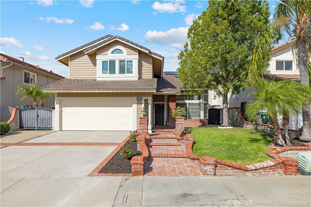 Welcome home to this beautiful property that is located in the Mountainview track in the heart of Saugus! The front yard is beautifully landscaped, featuring a mature peppercorn tree and large date palm trees that provide tranquility with ample shade and dimension. The brick stairway leads past manicured rose bushes to the front door. You are invited into a bright, naturally lit great room with cathedral ceilings and a giant bay window. The open floor plan showcases a gorgeous formal dining area with chair molding, giving a touch of class and sophistication. Through the doorway, you are welcomed to a thoughtfully designed chef’s kitchen that just screams organization and convenience. There is a two-tier lazy Susan in the corner cabinet as well as rolling shelving for smooth and easy access as well as a well appointed small pantry perfect for storing your smaller appliance. There is plenty of counter space for meal preparation and a breakfast bar. The kitchen is open to the family room, where a brick fireplace brings warmth into the home. The large window welcomes natural light throughout the downstairs. The upstairs features four bedrooms and two full bathrooms. The primary room has bright natural lighting and ample loft space for plants or even storage. There are two generously sized closets plus an attached ensuite bathroom. Vinyl flooring is laid throughout the entire upstairs. All four bedrooms have glass rolling closet doors which gives dimension to the space. Bedrooms one & three have loft spaces, and the middle bedroom features gorgeous, whitewashed wood paneling. Walking down the balcony hallway, you will come to find dedicated storage cabinets at the end of the hall with a granite counter. The backyard features a combination of fruit-bearing lemon, lime, and tangerine trees. The uncovered pergola and greenhouse provide great space for the hobby gardener to grow their plants as well as established peppers and herbs for the new owners to enjoy. The lot features plenty of space for all your toys: RV access for a small boat, motorcycle, or jet-skis, plus a storage shed in the backyard for more room to store your items. This property has solar that will be paid off, as well as newer HVAC, Water Heater, and Appliances.