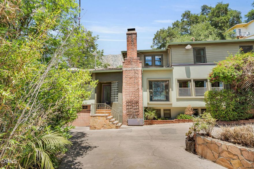 Tucked away in Sierra Madre's enchanting canyon neighborhood awaits this artistic custom-built hm with Art Deco influences. Known for its footbridges, river rock walls, meandering stream, & local wildlife, this area offers a rare blend of natural beauty & architectural charm. From the decorative 9' ceiling in the grand living rm, to the Mission tile in the thoughtfully updated bathrooms, this home is filled with fine detailing & unique craftsmanship. The dining room offers an ideal setting for entertaining & gatherings. A standout feature is the expansive 567 sf multi-purpose room with skylights, and vaulted truss ceiling, perfect for a home office with separate entrance, family room, gym, media room, or guest space. The updated kitchen is both stylish & functional, featuring custom cabinetry, pantry, breakfast bar and is open to a cozy den. Upstairs you'll find 3 bedrooms & 2 full baths, including a generous primary suite wrapped in windows with a beautifully remodeled bathroom. The lower level includes a large, flexible-use room with full bath & kitchenette, ideal as an in-law suite, guest quarters, playroom for children, or private retreat for teens. Recent upgrades include new roof, split-system units in all upstairs bedrooms, CA & heat in the multi-purpose room, new garage doors, and added plumbing, gas and electricity for an upstairs laundry area. This awesome home offers comfortable family-friendly living and is ideal for kids of all ages to explore and thrive!