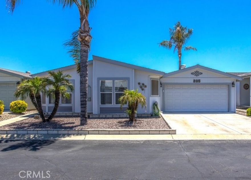 Welcome to The Foothills of Hemet—one of the most sought-after 55+ gated communities in the valley! This beautifully maintained 3-bedroom, 2-bath home with an attached 2-car garage is the perfect blend of comfort, convenience, and active living. Step inside to a light-filled, spacious living area designed for both relaxation and entertaining. The open-concept kitchen with a large center island and abundant cabinetry makes cooking and hosting a breeze. A formal dining room surrounded by windows brings in natural light and creates a warm, welcoming space for family and friends. The home also features a full laundry room with storage, and not just one but two outdoor patios—perfect for soaking up the California sun. On one patio, enjoy your own private 5-person jacuzzi in the enclosed screened room. On the other, breathe in the fresh scent of your very own citrus trees while you unwind. Living in The Foothills means access to two pools, pickleball courts, fitness and weight room, book room, and an inviting clubhouse with year-round activities. It’s an active, welcoming community designed for comfort and connection. Whether you’re looking to relax, stay active, or build friendships, this community has it all. Don’t miss your chance to own in this incredible neighborhood—schedule your private showing today and come experience the Foothills lifestyle!