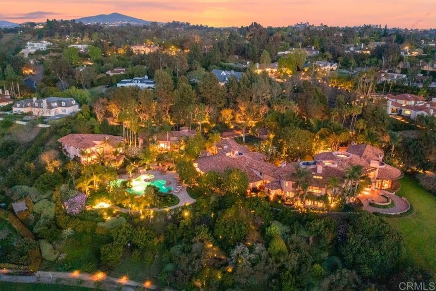 Introducing Villa Nafissa, an extraordinary legacy estate that redefines the art of luxurious living. Situated on an expansive 38.98 acres in the heart of Rancho Santa Fe’s highly esteemed Fairbanks Ranch, this unparalleled property is a sanctuary where the finest craftsmanship, nature’s beauty, and timeless elegance converge. Inspired by Claude Monet’s renowned gardens in Giverny, France, Villa Nafissa offers a rare opportunity to own a once-in-a-generation masterpiece. The estate’s lush grounds are a horticultural masterpiece, featuring more than 3,000 species of flora, fruit, and mature trees. With winding pathways, a serene lake, and cascading waterfalls, every inch of this extraordinary landscape has been meticulously curated to evoke the romance and tranquility of a Monet painting. The centerpiece of Villa Nafissa is the awe-inspiring main residence, a 16,000 square-foot custom-built estate that combines contemporary design with European elegance. The residence offers sweeping views of the meticulously landscaped grounds, including a picturesque lake. The entire estate boasts 19 total bedrooms (7 in main residence, 2 in clubhouse, 6 in guesthouse #1 and 4 in guesthouse #2), and unparalleled attention to detail, the home boasts the finest European craftsmanship, with marble floors and floor-to-ceiling windows that flood the space with natural light. The expansive living areas flow seamlessly into the surrounding gardens, providing an indoor-outdoor lifestyle unlike any other. Every detail, from the soaring ceilings to the luxurious finishes, speaks to the estate’s grandeur and exclusivity. Adjacent to the main residence is a private clubhouse, a 4,000 square foot gathering space that offers the ideal environment for hosting lavish events or intimate family gatherings. Overlooking the resort-style pool and hidden spa, the clubhouse includes a grand dining room, commercial-grade kitchen, media room, and an upstairs office suite. The estate’s two guest houses, totaling 10,000 square feet of living space, provide a level of privacy and comfort unparalleled in any other residence. Each guest house is self-sufficient, with spacious living areas, fully equipped kitchens, and en-suite bedrooms, offering an exceptional retreat for extended family or VIP guests. Nestled in private corners of the property, the guest residences offer sweeping views of the pool and gardens. Designed with the finest amenities, Villa Nafissa offers an enviable lifestyle that seamlessly blends recreation, wellness, and nature. The expansive grounds feature a gym, sports court, as well as a children’s play area and jogging paths that wind through the lush gardens. For moments of peace and reflection, the yoga and meditation gardens provide the perfect escape. As a true farm-to-table estate, Villa Nafissa is home to organic orchards and vegetable gardens, which supply the residence with fresh produce. The property offers the unique opportunity to stroll through acres of botanical beauty, from vibrant flower gardens to mature trees and water features. Equestrian enthusiasts will appreciate the estate’s zoning for up to 50 horses, with ample space to create world-class equestrian facilities, including stables, riding trails, and arenas. The estate’s dual-gated access provides an additional layer of privacy and convenience, with one entry point through the guard-gated Fairbanks Ranch community and a separate private entrance for owners, staff, or guests. This rare feature offers flexibility for both personal and professional use, ensuring that privacy and security are always prioritized while offering seamless access to the amenities of the Fairbanks Ranch community. Whether you are seeking a private family compound, a retreat for corporate events, or an equestrian estate, this compound provides endless possibilities. Villa Nafissa represents the epitome of elite living.