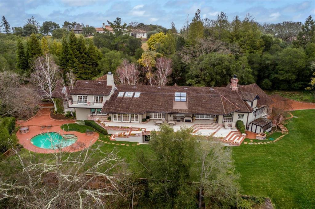 Custom rebuilt Hidden Valley / Farm Rd estate will not disappoint! On just over 3.25-acres, this 5,253 sq ft estate home was taken down to the studs, remodeled, expanded and structurally retrofitted over the years. The main residence has a spacious office loft and 4 bedrooms, including a main-level primary suite with 2 couture closet rooms and sumptuous marble bath. The large, detached building with executive office and overhead studio guest house, each with bath and kitchenette. Spacious terrace, pool, and vast stretches of lawn intertwined with walking paths encircling the entire property. Also suitable for up to 6 horses. This magical Woodside area is just minutes to 280, Sand Hill Road, Stanford University, and excellent Portola Valley schools. Luxurious livability, acreage, privacy, and every amenity needed for today.
