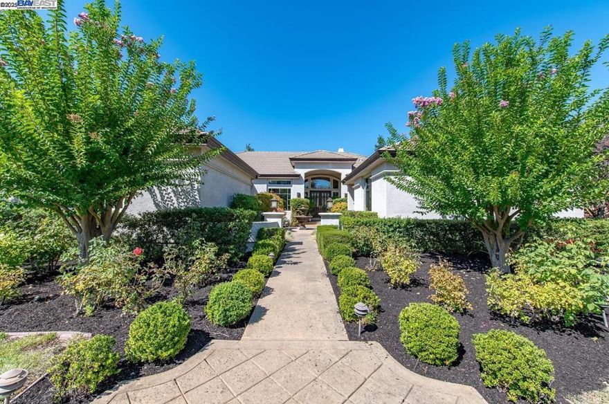 Welcome to 641 Varese Court, a beautifully appointed single-story home in Pleasanton’s prestigious gated community of Ruby Hill. Located on a quiet court, this 5-bedroom, 4-bathroom home offers 4,027 sq ft of comfortable, elegant living. The living room features a tiled fireplace and French doors to the backyard. The dining room includes engineered hardwood floors, crown molding, and recessed lighting. The open kitchen boasts a large island with bar seating, a Jenn-Air 5-burner gas range, stainless appliances, a Butler’s pantry with wine fridge and wet bar, and a walk-in pantry. A built-in desk and bright breakfast nook create a perfect family hub. The family room includes a stacked stone fireplace and media center. The luxurious primary suite has French doors to the patio and a spa-like bath. Three additional bedrooms and two bathrooms (one recently updated) are on the same wing. A fifth bedroom and full bath offer privacy for guests. The backyard includes a spacious patio, built-in BBQ, and lawn—ideal for entertaining. Enjoy Ruby Hill amenities: gated security, pool, fitness center, tennis, and more. Optional golf club membership available. Open House Saturday/Sunday 10/11 and 10/12 1-4pm.