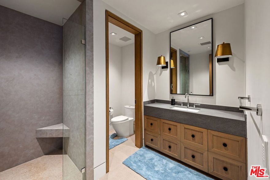 Exceptional Contemporary Estate in Beverly Hills. Located in the sought-after North of Sunset Blvd area, this new contemporary estate showcases state-of-the-art design and breathtaking panoramic city views. Spanning 11,127 sq. ft., the home seamlessly integrates modern elegance with indoor-outdoor living, featuring expansive glass walls that fill each room with natural light. The main level includes a sophisticated living room with a bar, a formal dining area, and a chef's kitchen that flows into a family room. The home offers a versatile guest bedroom or office on the main floor, two suites below, and four luxurious suites upstairs, including a master suite with a sitting area, dual baths, and a wrap-around terrace. Outdoor spaces include 4,000 sq. ft. of balconies and decks, plus a rooftop lounge. The lower level features a great room with a bar, a tiered theater, a gym with steam and sauna, and a wine room. The grounds boast a heated loggia, outdoor kitchen, pool, spa, and cabana, all framed by a stunning city backdrop. Complete with Crestron automation, a six-car garage, and an elevator, this estate offers the perfect blend of contemporary style and advanced technology, embodying the best in architecture, land, views, and location.