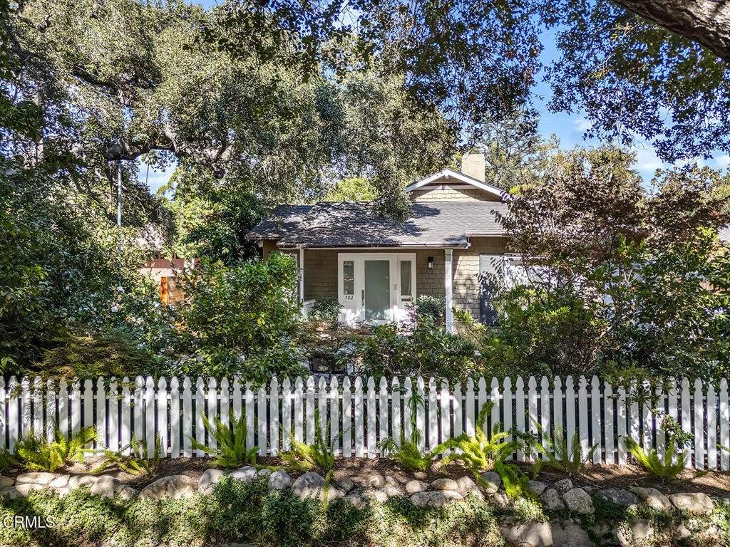 Sited behind a storybook white picket fence in Pasadena's coveted Arroyo district, this extensively renovated residence is a true one-of-a-kind retreat filled with modern amenities. Blending warmth and sophistication, the home's great room and kitchen serve as its heartbeat--over-sized island, soaring ceilings, floor-to-ceiling built-ins, walls of glass, and an artful use of light, stone, and wood create a welcoming space designed for connection and comfort.The luxurious primary suite offers a spa-like bath and generous walk-in dressing rooms, while more intimate corners of the home provide cozy places to unwind. Outside, lush gardens, a spacious patio, and the soothing sound of a fountain bridge the main residence to a charming two-room guest house. Complete with a bedroom, office, built-ins, and abundant natural light, the guest house currently features a half bath with easy potential to restore its original three-quarter configuration.Set in the heart of nature yet just moments from city conveniences, this home is steps from the scenic trails and native beauty of the Arroyo Seco. Equal parts sanctuary and entertainer's haven, it is truly a special place to call home.