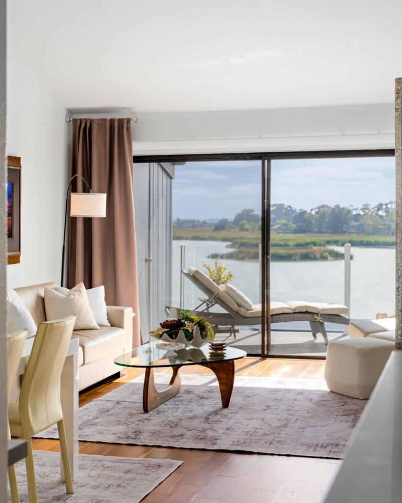 Directly on the lagoon with ocean views, this fully furnished meticulously renovated Carlsbad condo offers a rare blend of coastal charm and modern luxury. Every inch of this designer-inspired home has been transformed with bespoke upgrades, high-end materials, and thoughtful details. Nearly $200K in recent remodeling. The reimagined entry welcomes you with custom quartz stairwell ledges, floating Acacia wood floors, ambient lighting, and a built-in coat closet with charging station. A chef’s dream, the vaulted-ceiling kitchen boasts push-to-open European cabinetry, imported Italian granite walls, quartz counters, under-cabinet lighting, and premium Frigidaire and European appliances. Entertain in the stunning living room with a sleek fireplace, floating cabinetry, a wine fridge, and a statement granite feature wall. Both bedrooms present new high-end carpets and custom window treatments. Bathrooms showcase waterfall faucets, rosewood vanities, and artisan tilework. Relax outdoors on two lounge patios with custom faux grass, granite-topped cabinetry, and private seating areas—perfect for hosting or unwinding, all with stunning ocean views. Additional highlights include a newly upgraded electric panel, programmable smart lock, custom trim throughout, and sound-dampening underlays. This turnkey home offers coastal California living at its finest—just steps from the beach, yet miles above the ordinary. Experience the "Private Carlsbad Sanctuary."