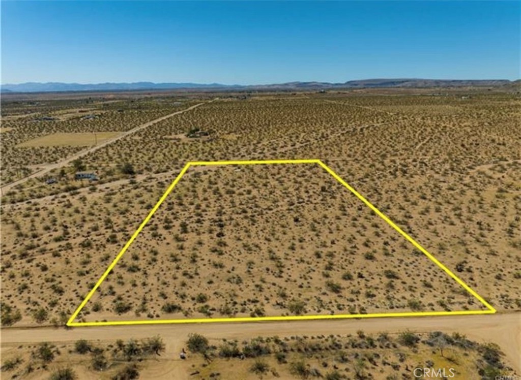 5 Acres of Untapped Desert Potential – Power & Water at the Street! Discover the freedom and opportunity of owning five expansive desert acres—a blank canvas ready for your vision. Whether you're dreaming of building a custom home, launching a unique retreat, or investing in land with future potential, this lot offers a rare mix of seclusion and accessibility. With water and power conveniently available at the street, your path to development is streamlined from the start. The location offers the kind of privacy only the desert can deliver, while still being just minutes from local favorites like LA Copine, Giant Rock Meeting Room, and nearby gas stations and convenience stores.And for the adventurers—Giant Rock and its surrounding wilderness are only 10 minutes away, inviting you to explore, hike, and disconnect in one of the desert's most iconic landscapes. A fictitious address has been used for easier GPS navigation. Lot lines are approximate; buyers to verify all utilities and boundaries during due diligence. Your desert dream starts here.
