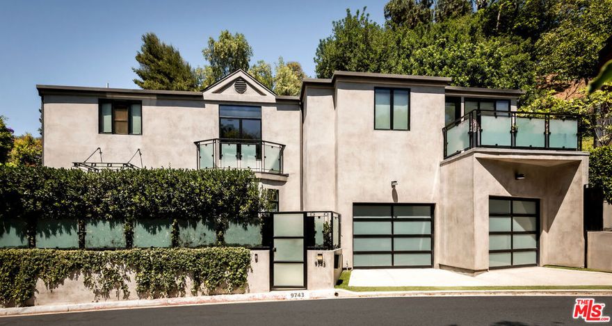 Bathed in natural light, this gated contemporary captures the essence of California living with its seamless indoor/outdoor design and serene garden setting. The expansive living room flows to an inviting cabana dining space perfect for year-round entertaining under the Beverly Hills sky.  A sleek European kitchen opens to the formal dining room and out to a lush meditation and flower garden that wraps the property in color and calm. The oversized primary suite offers dual spa-inspired bathrooms, a generous custom closet, and a private terrace with treetop views. A bright secondary suite provides the perfect complement for family or guests. Moments from the iconic Beverly Hills Hotel and the heart of the city, this rare retreat embodies timeless California style in one of the world's most celebrated neighborhoods.