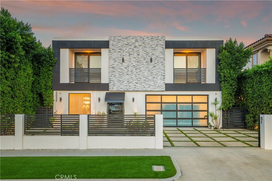 South of the Boulevard and just minutes from Encino Commons, this turnkey custom home blends modern comfort, high design, and everyday security seamlessly. Built in 2019 with designer craftsmanship, it has been meticulously maintained ever since. A gated motor court accommodates up to four cars before reaching the attached garage. 10 foot ceilings open the space up instantly upon entry, where a formal dining room rests alongside the entering corridor leading into the main living area. The sunken family room is bright & airy, and connects to the plush kitchen and also leads into the yard through giant fleetwood doors. Resort style backyard starts with a covered patio with built in speakers, features a cabana, large grass pad, and heated pool with tub. Super private in the backyard and the perfect place to gather, party, relax, or use as a playground for kids. Inside the home are 4 bedrooms, all equipped with en suite bathrooms. One bedroom down, three bedrooms up. Each of the three upstairs bedrooms enjoy a private balcony, with the master’s spanning nearly the entire width of the home overlooking the yard. The master also has a generous walk-in closet with skylights and custom built in organizers/dressers. Laundry room upstairs as well, right outside of a large landing pad in between the rooms, which is also another valuable space for additional furniture, shelves, study area, etc. The garage can be used for cars, a gym, extra room, or an office- it includes A/C and heat and tile floors. Home also features 3 A/C and heating zones, solar, security cameras, and a roll down security shutter. Easy access to Encino's best amenities including top-rated schools, Equinox, Trader Joe's, Encino Commons, Balboa Park, Los Encinos State Historic Park, El Caballero Country Club and the 101 freeway.