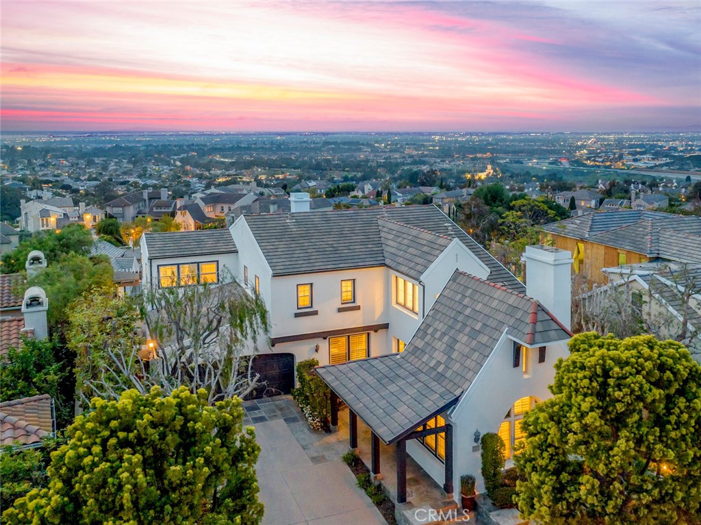 Perched on a commanding sit-down view lot, 23 LeMans captures breathtaking vistas of the Pacific Ocean, Palos Verdes Peninsula, Long Beach Harbor, and dazzling city lights stretching from Orange County through downtown Los Angeles, and on clear days, even snow-capped mountains grace the horizon. This is arguably the best view property in all of Newport Ridge North, THE prestigious DUAL guard-gated community in Newport Coast.
Tucked away on a quiet cul-de-sac, the home offers privacy, comfort, and relaxed coastal luxury. Set on approximately 7,492 square feet of ultra-private grounds, the outdoor areas are designed to impress, whether you're hosting intimate gatherings or entertaining on a grand scale. A built-in barbecue and spa that is accented by a cascading fountain, create a serene, resort-like ambiance.
Inside, nearly 3,680 square feet of thoughtfully designed space offers soaring ceilings, hardwood floors, recessed lighting, and custom window coverings. The open-concept layout flows effortlessly through the main level, connecting the living and dining areas. The chef’s kitchen features stainless steel appliances, a butler’s pantry, and a large eat-in island, all seamlessly opening to the living space and backyard. The formal living room with fireplace, a bonus space off the great room, and a main-level office that can easily be converted to a fourth bedroom, round out the downstairs.
Upstairs, the spacious primary suite is a true retreat, featuring an oversized walk-in closet, dual vanities, soaking tub, and separate walk-in shower. Step out onto your private balcony and take in those sweeping ocean and city views, the perfect setting for morning coffee or a glowing sunset. Two additional bedrooms share a dual-entry bathroom, with a laundry room nearby for added convenience.
Living in Newport Ridge North means access to resort-style amenities, including a private clubhouse, tennis and basketball courts, parks and playgrounds, pool and spa. With two guard-gated entrances, one connecting to Newport Coast’s shopping, dining, beaches, and scenic trails, and the other offering direct access to Newport Beach, Fashion Island, top-rated schools, and John Wayne Airport, you are truly at the heart of it all!