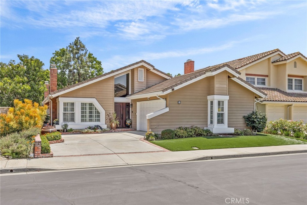 Nestled in a quiet cul-de-sac within the prestigious GATED enclave of Wind Stream, this beautifully UPGRADED SINGLE-STORY home offers the perfect balance of comfort, privacy, and location. Blending classic American charm with Pottery Barn–inspired style, the interiors showcase warm textures, crisp lines, and timeless finishes. Rich wood floors, a classic brick fireplace, and elegant details create a welcoming atmosphere that feels both stylish and lived-in. The formal living and dining rooms offer warmth and elegance, enhanced by vaulted ceilings, hardwood floors, and a classic brick fireplace that anchors the space with timeless charm. The front STUDY impresses with WALNUT-PANELED WALLS, custom BUILT-INS, recessed LIGHTING, and WOOD FLOORING —perfect for a private office, creative studio, or elegant library. At the heart of the home, the open-concept kitchen and family room combine timeless design with modern convenience. The kitchen is equipped with STAINED MAPLE cabinetry, QUARTZ countertops, MARBLE backsplash, a DOUBLE OVEN, BOSCH dishwasher, and a center COOKTOP ISLAND. A SKYLIGHT above brings in soft natural light, creating a cheerful and welcoming ambiance. The adjoining family room features a cozy river rock FIREPLACE and a natural wood ACCENT WALL. Vaulted ceilings and rich wood flooring enhance the spacious feel, while a sliding glass door opens directly to the tranquil backyard for easy indoor-outdoor living. The primary suite is a private retreat with vaulted ceilings, clerestory window, wood flooring, and direct backyard access. The remodeled en-suite bathroom includes dual sinks with quartz counters, white cabinetry, a linen tower, and a large stone-tiled walk-in shower with built-in seat, rainfall and handheld showerheads. A skylight and walk-in closet complete the suite. The backyard is thoughtfully landscaped with new pavers, two aluminum patio covers with drapery and string lights, a tranquil fountain, lush planters, and a gravel seating area with raised garden beds—perfect for relaxing or entertaining. Additional upgrades include: newer AC unit, WATER SOFTENER, REMODELED bathrooms, fresh interior PAINT, FIBERGLASS front door, shutters and automated HUNTER DOUGLAS shades, 50-GALLON water heater, EPOXY garage flooring, GUTTERS, and more. Enjoy resort-style amenities including pool, jacuzzis, BBQ area, tennis courts, and direct trail access to Hicks Canyon. Homes in Wind Stream rarely become available—don’t miss this special opportunity.