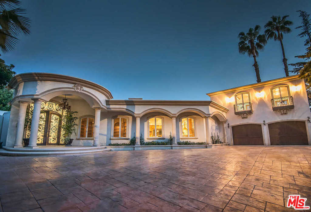 A rare offering -- One of the few residences in Trousdale Estates with two levels above ground. Including over 7200 square feet of space and a half acre of land, this home has incredible potential for a developer or owner/user, with a pool/spa, grassy yard and views of the city lights an ocean. The current contemporary floor-plan features a guest suite, a chef's kitchen featuring two oversized islands, and master bedroom suite with dual bathrooms, walk-in closets, office/library, walls-of-glass and an expansive deck. Priced to sell.