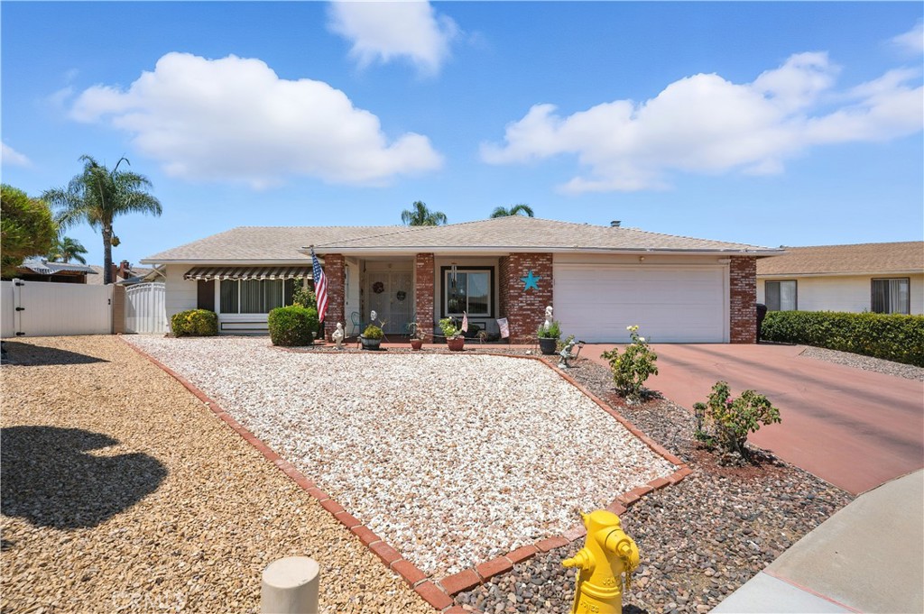 Welcome to this outstanding Senior 55+ pool home, no HOA, in a quiet cul-de-sac, offering 3 bedrooms, 2 bathrooms, and 1,984 sq. ft. of beautifully maintained living space on a 10,890 sq. ft. lot. This rare Presley 39 model has been expanded to include a spacious family room/great room with a cozy brick fireplace and mantle—perfect for relaxing or entertaining. From the moment you arrive, you’ll be greeted by a beautifully etched beveled glass double door, covered porch entry leading to a large formal living room and a formal dining room with a mirrored wall for added elegance. The updated kitchen features refinished cabinets, beautiful granite countertops with bar seating, gas range, microwave, and recessed lighting. Both bathrooms have been upgraded with granite countertops and stylish mirrors. The primary bath shower showcases elegant tile work. One of the three bedrooms is ideal for use as an office, study, or den. Step outside to a pie-shaped lot with a low-maintenance rock-scape front yard and a grassed rear yard equipped with a sprinkler and drip irrigation system. A low brick retaining wall separates the yard from the sparkling in-ground pool, A large wood patio cover with ceiling fans stretches nearly the full length of the home, providing a comfortable outdoor retreat. A standout feature is the detached 540 sq. ft. workshop—accessible by golf cart—with an attached air-conditioned craft/sewing/exercise room. There’s also a two-car garage with newer garage door, attic ladder for extra storage, and laundry area. Additional upgrades include a newer roof installed about 1.5 years ago, newer water heater (2022), and a whole house fan for added comfort, and energy saving dual pane windows. Built in 1983, this home is truly turnkey and ready to enjoy.
