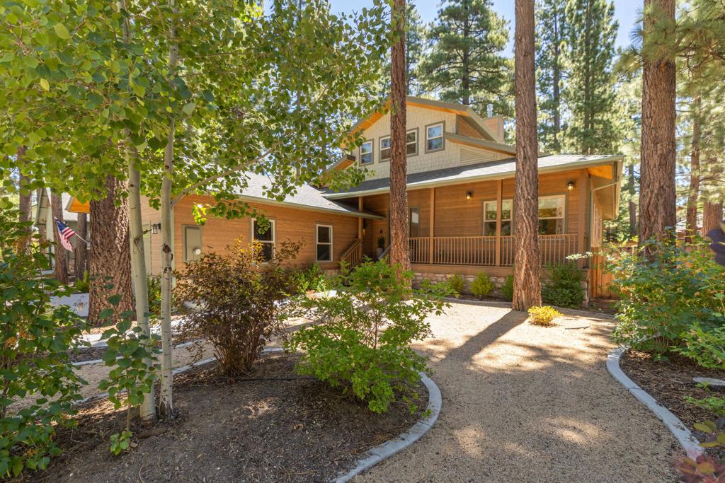 Located in the prestigious Eagle Point Estates, this custom mountain home offers the perfect blend of luxury, comfort, and lakeside living. Enjoy community amenities including a private boat dock, tennis court, and tranquil setting in one of Big Bear Lake's most desirable neighborhoods. Designed for both style and function, this single-story home with a spacious loft features soaring ceilings--10 to 25 feet in the main living areas--paired with expansive high windows that fill the space with natural light. Warm up beside one of the two fireplaces, and enjoy a gourmet kitchen complete with granite countertops and copper plumbing with recirculating hot water. Engineered oak flooring, fiber cement siding with a rustic aesthetic, and a durable composition roof enhance the home's charm and durability. Step outside onto covered Trex decks at the front, side, and rear, perfect for entertaining or simply enjoying the fresh mountain air. The fully fenced lot includes a beautifully landscaped yard with a waterfall feature, adding privacy and serenity. The oversized garage offers ample space for vehicles and storage. Additional highlights include whole-house fans, extra insulation, residential fire sprinklers, and the property comes furnished per inventory. This 3-bedroom, 3-bath home is a rare opportunity in a quiet, upscale lakeside community just minutes from ski slopes, marinas, restaurants, and shops.