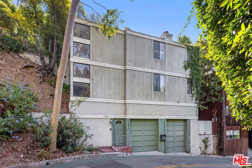 Trust Sale - No Court Confirmation Required. Tucked away on Alcyona in the coveted Hollywood Dell, this 3-bedroom, 3-bath retreat offers tranquility, privacy, and exceptional potential. Surrounded by mature trees and lush greenery, the property is a peaceful sanctuary a short distance from numerous exciting amenities including Franklin Village, the Hollywood Bowl, and the Griffith Observatory. The spacious residence boasts an open-concept floor plan with seamless indoor-outdoor flow, where the expansive living room connects to the dining and kitchen areas, which open to a private brick patio- ideal for entertaining or quiet relaxation. Upstairs, the generous primary suite captures treetop views and serves as a serene retreat, and is complemented by two additional bedrooms that provide flexibility for family, guests, or a home office. The two-car garage is a useful convenience in this highly sought-after neighborhood, while ample storage throughout enhances livability. With nearby homes trading at significantly higher values, this rare offering presents outstanding potential and the opportunity to create your own private Hollywood Dell retreat.