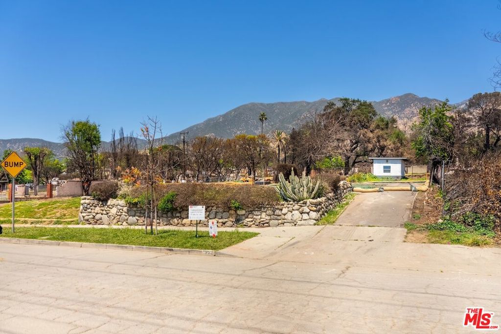 This desirable rectangular parcel offers approximately 7,159 sq ft of prime Altadena land. Zoned LCR175 (low-density residential), it presents an excellent opportunity to design a custom home with mountain views. According to public records, the previous 1,480 sq ft home with 3 bedrooms, 2 bathrooms, and a detached 2-car garage was lost in the Eaton Fire. A 130 sq ft detached studio remains intact. Phase 2 Debris Removal has been completed, and the lot had access to all utilities before the fire. The original river rock retaining wall and large flagstone pavers still remain, adding a sense of character and charm. The sellers valued their time here, enjoying hikes, peaceful evenings, and the natural beauty of Altadena and its close-knit community. The property is being sold as-is, for land value only, but full of potential and ready for its next chapter.