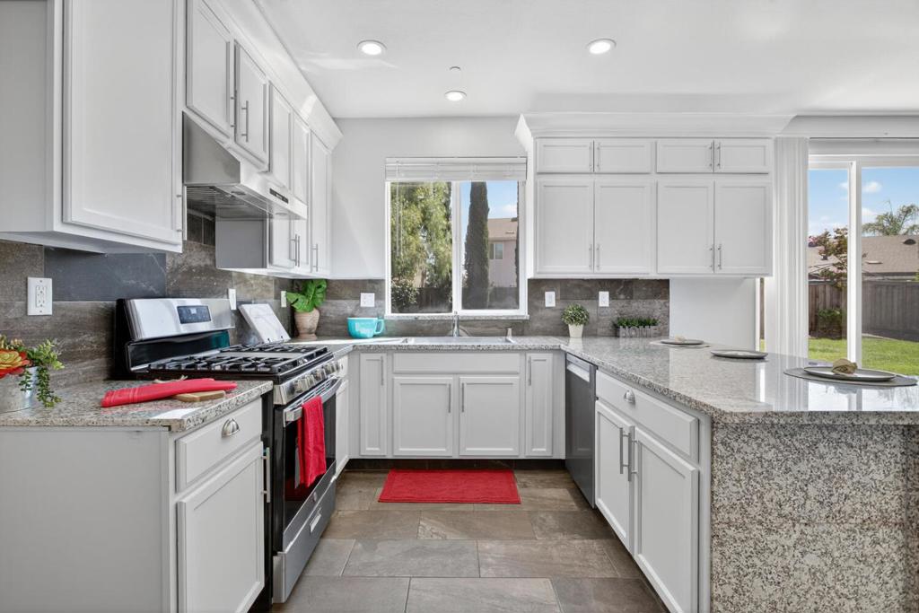 Fall in love, truly a rare and stunning 5 Bd 3 Ba home, nestled on a peaceful, highly desirable cul-de-sac. The moment you step inside, you'll be captivated by the open-concept main level, where soaring 9-foot ceilings and gorgeous red oak hardwood floors create an immediate sense of grandeur. The kitchen features elegant new granite countertops and a massive 33 in farmhouse sink. The must have island makes it the perfect hub for gathering friends and family. The massive master suite is a luxurious retreat with an enormous walk-in closet, while the entire second floor and stairs are finished with new waterproof laminate flooring. The master and hall baths feature new defogging mirrors. A downstairs bedroom offers a perfect, private space for guests or multi-generational living. Every corner is bathed in light from 32 brand-new LED lights, and new 5.5-inch baseboards add a final touch of polish. Step outside to your private, low-maintenance oasis. The backyard features a French drainage system and a treasure trove of mature citrus and peach trees, providing fresh fruit all year long. Just walk n turn the corner to the award-winning Peyton Elementary n Middle schools n the community park. Easy access to FWY 99, 4, and 5. Plus, nearby Costco, Walmart, Lowes, Home Depot & etc: NO HOA
