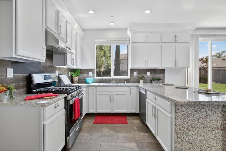 Fall in love, truly a rare and stunning 5 Bd 3 Ba home, nestled on a peaceful, highly desirable cul-de-sac. The moment you step inside, you'll be captivated by the open-concept main level, where soaring 9-foot ceilings and gorgeous red oak hardwood floors create an immediate sense of grandeur. The kitchen features elegant new granite countertops and a massive 33 in farmhouse sink. The must have island makes it the perfect hub for gathering friends and family. The massive master suite is a luxurious retreat with an enormous walk-in closet, while the entire second floor and stairs are finished with new waterproof laminate flooring. The master and hall baths feature new defogging mirrors. A downstairs bedroom offers a perfect, private space for guests or multi-generational living. Every corner is bathed in light from 32 brand-new LED lights, and new 5.5-inch baseboards add a final touch of polish. Step outside to your private, low-maintenance oasis. The backyard features a French drainage system and a treasure trove of mature citrus and peach trees, providing fresh fruit all year long. Just walk n turn the corner to the award-winning Peyton Elementary n Middle schools n the community park. Easy access to FWY 99, 4, and 5. Plus, nearby Costco, Walmart, Lowes, Home Depot & etc: NO HOA