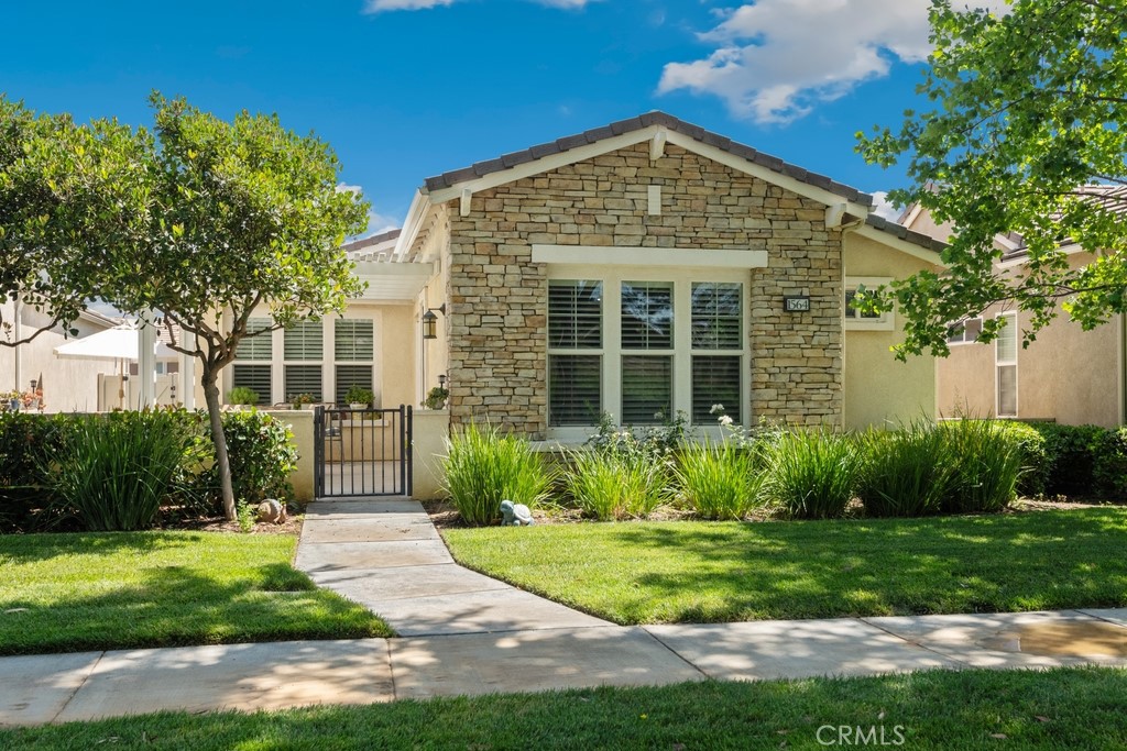 Resort-style living awaits in this beautiful home in the guard-gated 55+ community of Four Seasons by K. Hovnanian in Beaumont. Enjoy tree-lined streets, manicured landscaping, and exceptional amenities including a clubhouse, gym, pool, spa, tennis courts, and scenic walking trails. This charming home features a welcoming pergola-covered front patio, a cozy living room with fireplace, wood shutters, and laminate flooring throughout. The kitchen boasts a spacious island with bar seating, pantry, and adjoining dining area. A flexible office/den, full guest bath, and guest bedroom offer versatile living space. The private primary suite includes a walk-in closet and dual sink vanity. Attached 2-car garage completes the home. Move-in ready and designed for comfort in a serene, amenity-rich setting.