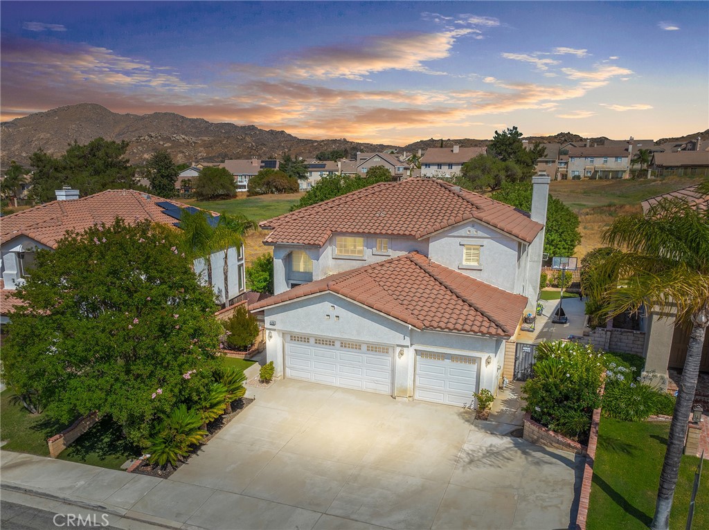 Low low tax and no HOA!! Welcome to the very best of both worlds in one of Eastern Moreno Valley’s most sought after neighborhoods, where you can maximize and enjoy peaceful living while being a few minutes away from shopping, entertainment, easy access to the 215 and 60 freeways! This RARE floor plan features 4 bedrooms, 3 full bathrooms! No expense has been spared in timeless custom upgrades! As you enter the home through the double doors, you will notice the cathedral ceilings, plantation shutters and neutral stunning laminate flooring throughout downstairs. The formal living room and dining room leads to the heart of the home where a chef’s kitchen features another dining area, modern granite counters with gorgeous island and bar height seating, appliances to include double ovens and stainless steel stove and microwave. The kitchen opens up to a large family room with cozy brick fireplace and adorned with windows for natural light. There is a downstairs bedroom with full bathroom perfect for overnight guests or live-in relatives. Upstairs features include an expansive primary bedroom suite with a balcony where you can enjoy breathtaking views and private bathroom with dual sinks, shower, soaking tub and walk-in closet. An additional two well proportioned bedrooms share a secondary upstairs bathroom with dual sinks. Enjoy the beauty of nature from your secluded back yard as the property backs up to golf course views providing privacy and a sense of tranquility with no rear neighbors. The drought resistant landscape adds an eco-friendly touch ensuring a low-maintenance and sustainable lifestyle. More features include whole house soft water system, separate laundry room with utility sink, an extended large driveway and a 3 car garage that offers plenty of room for your vehicles and storage needs. With proximity to parks, the Rancho del Sol Golf Club, Lake Perris Regional State Park and Moreno Valley College, this home offers both convenience and serenity. And with no HOA, it's an opportunity not to be missed! This home is ideally situated near Kaiser Hospital, this location offers exceptional convenience for medical professionals and anyone seeking easy access to quality healthcare.This home combines comfort, style and practicality, making it a perfect choice for those seeking a well-maintained property.