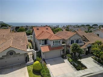 Breathtaking Ocean-View Retreat with Modern Elegance located in gated community of Regatta! Enter into your private Zen like courtyard that wraps around to the back patio. Experience coastal living at its finest in this stunning 3-bedroom, 2-bath home featuring an open floor plan designed for both comfort and style. Step into a light-filled living space with expansive windows that frame panoramic ocean views, creating a serene backdrop for everyday life. Large deck welcomes you to views of the great Pacific Ocean and gorgeous sunsets! Have your morning coffee, enjoy wine after a long day, host a fun BBQ or work on our tan! Anything is possible! The heart of the home is a contemporary, state-of-the-art kitchen equipped with upgraded stainless steel appliances, sleek countertops, and ample cabinetry—perfect for entertaining or enjoying quiet meals at home. Adjacent to the kitchen, the dining area flows seamlessly into a spacious living room highlighted by a cozy fireplace. 2 private bedrooms off the living space could be used as a home office, a gym or just traditional bedrooms. Both rooms have access to a deck that has views of the hillside and sunrises. There is a remodeled bath in between the rooms. A few steps downstairs and you can retreat to the romantic primary suite, a true sanctuary complete with its own fireplace and access to your private patio that has a cover for shade. The spa-inspired primary bath offers a luxurious escape with abundant natural light, elegant finishes, and a serene ambiance. Oversized walk in shower with multiple shower apparatus, a deep soaking tub, polished vanity with custom mirrors and did I mention a great skylight to allow natural light for the perfect make up application! Huge walk-in closet can house your extensive wardrobe!
Attached 2 car garage has storage as well as laundry facilities. Every detail in this home has been thoughtfully curated to offer the ideal blend of modern design and coastal charm. Whether you're hosting guests or unwinding in your private oasis, this home delivers the ultimate in California coastal living. BONUS!! A resort like community pool and spa located within walking distance. Nearby shops, casual and fine dining, water sports, whale watching, sunset cruises, beaches and Dana Point Harbor located nearby!