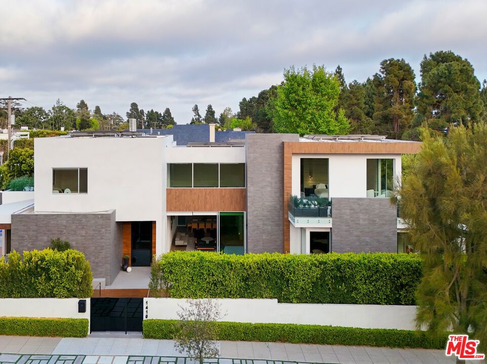 A huge price reduction makes this one of the best deals North of Montana! This modern masterwork smart home of exquisite design is positioned on a large lot on one of the most coveted streets in this prestigious, highly sought neighborhood. Including the outstanding car gallery, this remarkable property offers over 10,000 interior square feet. The current owner invested an estimated $4 Million in upgrades and extraordinary top-of-the-line finishes throughout this already-new property, revealing a marvelous work of art to provide the ultimate lifestyle rich in luxury. Massive motorized 25-foot Fleetwood sliders create uninterrupted flow from the extensively expanded chef's kitchen and grand living room opening to limitless outdoor entertaining possibilities with an infinity pool, free-throw basketball court, and built-in barbecue station. A double-height entry with newly installed art wall and 30-foot wall of intricate walnut accentuate a floating staircase leading to the top-floor primary suite with private terrace and views of the Santa Monica Mountains. Five additional en-suite bedrooms, a state-of-the-art professional-grade movie theatre, gym, music room, and office are all appointed with precision craftsmanship and fine custom finishes. An impressive 2,300-square-foot underground auto gallery is equipped with a rotating electric carousel to delight any automotive enthusiast. Discover Fleetwood windows and doors, motorized shades, a Cambridge elevator, and Meile and Sub-Zero appliances including two new wine refrigerators in the culinary center of the home. Additional features include a comprehensive Crestron automation system with full-home integration, solar panels, electric pool cover, water purification system, tankless water heaters, Agenta pivot hinges, solid walnut doors, electric skylights, a basement level, upgraded multi-zone HVAC system, and more. Welcome!