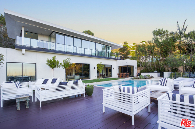 Extraordinary new contemporary estate on private lane behind gated motorcourt entry. Nearly ¾ acre of tranquility set amid nature with mature trees surveying perfectly framed City- to-Ocean views and green canyon vistas. Entry Courtyard leads to dramatic Foyer and open Living Room Gallery offering high ceilings and wall-to-wall Fleetwood doors allowing direct passage to the enormous Poolside Lounge & yard. Grand open Kitchen displays ebony cabinetry, massive stone slabs & supreme appliance technology while offering backdrop for inspired cooking & entertaining. Family Rm is adjacent to outdoor Grill & Bar. 3 bdrm suites plus Art Studio/Office are located on main level. Upstairs is entirely Master Suite domain beginning with art gallery vestibule that leads into double bath suites, dual dressing rm closets, multiple terraces, firelit Den retreat and dazzling city lights view. An unforgettable bedroom sanctuary that must be seen. The epitome of Sunset Strip lifestyle is enjoyed here.