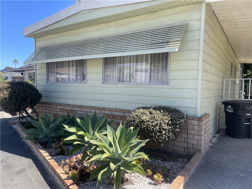 Beautiful drought resistant desert landscaping on extra large corner lot located in desirable Skyline Mobile Home Park. Lots of room for gardening. An extra large porch to enjoy the summer evenings. Included are shed, all appliances + washer & dryer. Home offers laminate flooring and has been well maintained. A little upgrading would make this your dream home. Exterior has brick front and two car carport parking. Skyline MHP offers many amenities such as pool, jacuzzi, two pool tables, outside barbeque area with many activities. Right across the street from Rollling Hills Plaza, which includes Trader Joes, Whole Foods, Starbucks, as well as other fine restaurants, AMC Theater.
