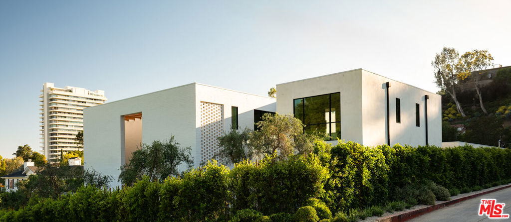 "FIVE FATHOMS"- The latest creation by celebrity designer Jae Omar and architect Eran Gispan, is a residence of lyrical beauty and organic architectural reverence. Set on a sprawling 20,000 square foot lot, this 9,800 square foot residence unfolds across five distinct structures, thoughtfully connected by glass-encased walkways that 'float' over meandering waterways. The interior aesthetic showcases Omar's signature 'organic modern' approach, featuring a textural symphony of sandblasted stone, vanishing walls of glass, and meticulously crafted white oak accents that converge in perfect harmony. The primary suite stands as a singular retreat, complete with a private library, a vast deck, and an ethereal stone-wrapped bathroom that is cloaked in natural light from strategic skylights that continue into the custom walk-in closets. Additional features include ADU, conceived as a serene wellness retreat, a 65-foot swimming pool adorned with a grand spa and cold plunge, expansive cobblestone terraces, multiple outdoor fireplaces, a fully equipped alfresco kitchen, state-of-the-art Dolby theatre and a cutting-edge security system with voice-activated infrared technology. 'FIVE FATHOMS' - A legacy of contemporary design and luxury living!