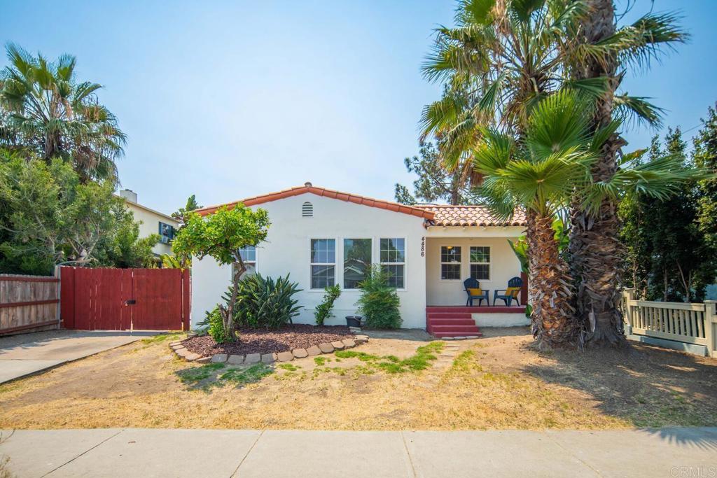 This Charming 3-bedroom, 2-bath Spanish Bungalow located in Normal Heights, is just a short walk from dynamic Adams Avenue. This home beautifully blends classic charm with modern updates. Upon entering, you'll be greeted by the original fireplace and gleaming hardwood floors throughout. The main living area features coved ceilings and arches, adding to the home's unique character. The primary bedroom boasts an ensuite bathroom and direct access to the back covered deck. The two additional bedrooms are spacious and filled with natural light. Comfort is ensured year-round with a new heater and ceiling fans. The property offers an inviting front porch, perfect for enjoying evening breezes, and a large covered deck in the back, ideal for relaxing and entertaining. For your convenience, the home also includes a stacked washer and dryer in the laundry room, a large 2-car garage, and four secure off-street parking spots. The spacious, fenced backyard is a blank canvas, ready for your creative touches. You might even consider taking advantage of the R-3 zoning to add an ADU above the garage! Its ideal location near Adams Avenue and 30th Street provides easy access to the vibrant dining, shopping, and entertainment options in North Park and Normal Heights, along with quick freeway access.