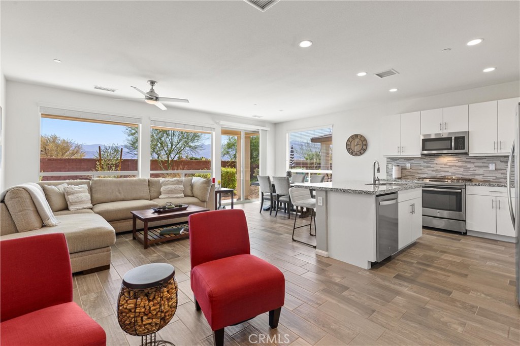 Discover effortless living in this beautifully maintained Aria model home, located in Trilogy Polo Club's exclusive 55+ neighborhood. Perfect as a full-time primary residence or secondary vacation home, this 2-bedroom, 2-bath residence offers the perfect blend of style and low-maintenance convenience.
Step inside to wide-plank tile flooring that flows throughout the open-concept living spaces. The thoughtful split-bedroom layout ensures privacy, with the primary suite positioned opposite the guest suite. Both bedrooms feature fresh carpeting for added comfort.
The chef's kitchen showcases granite countertops, an attractive backsplash, and premium appliances including a stainless steel gas range, microwave, and GE Profile side-by-side refrigerator. A versatile flex room houses the washer and dryer while providing space for a home office or craft studio.
Both bathrooms have been elegantly updated with floor-to-ceiling ceramic tile showers featuring built-in benches and granite vanities, creating a spa-inspired atmosphere.
Your private patio offers stunning mountain views of the Santa Rosa and Chocolate Mountain ranges, complemented by professionally maintained landscaping.
As a resident, enjoy access to the spectacular 25,000 sq ft Polo Club featuring June Hill's Table restaurant, three outdoor pools, state-of-the-art fitness center with Afturburn program, yoga studio, pickleball and tennis courts, bocce, golf simulator, game room with billiards, artisan and culinary studios with chef demonstrations, and 19 parks woven throughout the community. A full-time Lifestyle Director ensures endless opportunities for connection and recreation.
Located just 25 miles from Palm Springs International Airport with easy I-10 access, shopping nearby, and over 100 world-class golf courses in the region, this turnkey home offers the ultimate desert lifestyle. Schedule your private showing today!