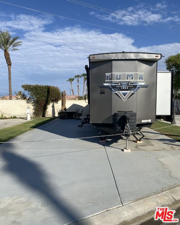 This Destination Tailer Home is unique to Rancho Casa Blanca. It is a 2 bedroom home with all the amenities of a a travel trailer. This is a brand new 2024 unit, never lived in. It is hooked up to the permanent sewer and electricity. It is ready to finish the outside with decking, if preferred, or keep it as is. This is a steal for sure. This all located in a 55+ community that has a 3 par golf course, chipping green, putting green, 9 hole mini golf, pickleball and tennis courts, bocce ball, an indoor shuffleboard courts, 2 clubhouses with pools and jacuzzies and an additional 4 satellites with pool, jacuzzies and mail boxes. This is all within a 24 hour gate guarded community of 801 lots, that consist of a combination of Park Models and RV lots, where you own the land. The resort has a limit of 270 day occupancy. It is a perfect place to spend your holidays in the sunshine.