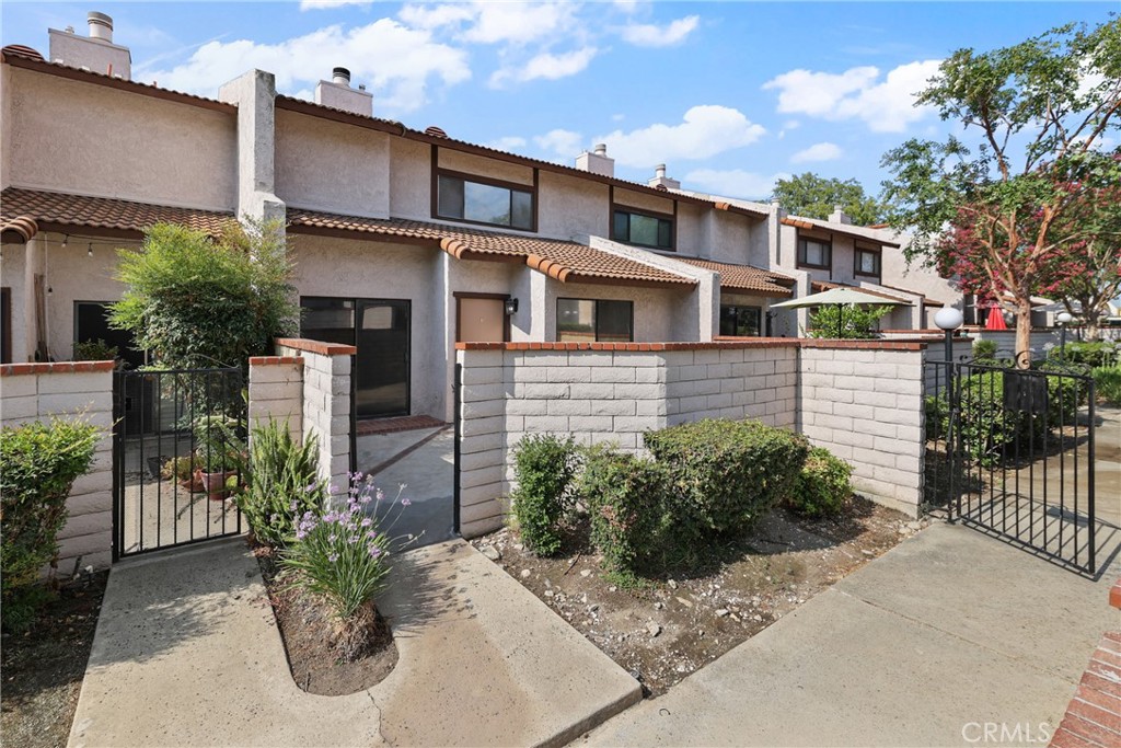 Welcome home to this beautiful, move-in ready townhome that has lovely mountain & pool view. Desirable Park Hacienda community in Upland. This two-story townhome has approximately 1,464 square feet of living space, 3 bedrooms & 2.5 bathrooms with the half bath downstairs for convenience. This lovely townhome is ready for your personal touch. Features: fenced-in nice size front patio area with a gate leads you to the front door, bright, light & airy floor plan with tile entryway, brand new carpeting throughout, fresh interior paint, new blinds, ceiling fans & more! Lovely formal living room with a fireplace. Cozy kitchen opens to large nook/dining area. A generous primary suite features walk-in closet & primary bathroom. Attached, finished 2 car garage with direct access & metal garage door. Tile roof. Association Includes: sparkling pool, spa, tennis/pickle ball court, club house, water, trash, pet friendly, ample guest parking & maintenance of community greenbelts grounds with some picnic area & lovely walkways. Upland Unified School District. This property is conveniently located close to parks, schools, shopping centers, grocery stores, Colonies Crossroad center that also offers more shopping & restaurants. Plus commuter friendly with 210 & 10 freeway near-by PLUS added bonus of the Metro Link station in the downtown Upland Village. Hurry, this townhome will not last!