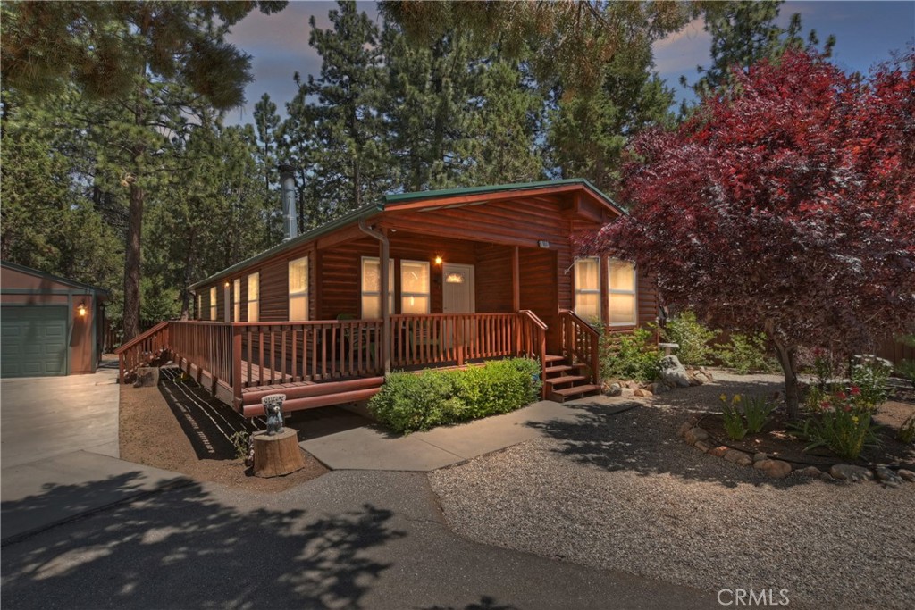 Charming Mountain Retreat in Big Bear City! This 3 bed, 2 bath log-sided home offers 1,557 sq ft of cozy living on a 7,500 sq ft lot in the desirable Peter Pan neighborhood. Built in 2003, it features a wrap-around deck, hot tub, and beautifully landscaped front yard. Enjoy the mountain lifestyle with a rustic exterior and modern comforts. Detached 2-car garage adds convenience. Perfect as a full-time residence, vacation home, or short-term rental. Located near Big Bear Lake, ski resorts, hiking, and dining. Don’t miss this Big Bear City home for sale with mountain charm and outdoor living.