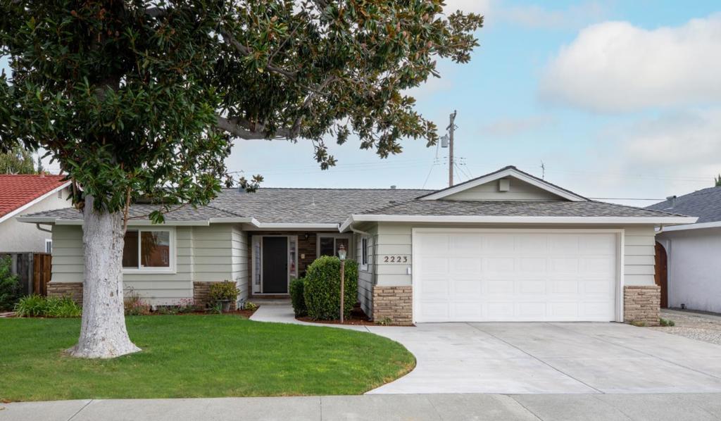 Eye-catching home in the heart of Santa Clara, freshly painted inside and out, with natural light streaming through two skylights and luxury vinyl flooring. The step-down living room and adjacent family room with a wood-burning fireplace create inviting spaces to relax or gather with friends and family. The dining room with wainscoting flows to a bright kitchen featuring quartz countertops, a 5-burner cooktop and abundant cabinetry, perfect for everyday meals or entertaining. Two bedrooms designed for relaxation, one with a charming window seat ideal for reading or morning coffee. The spacious primary retreat has new carpet, dimmable lights, ceiling fan, and French-style glass door opens to the backyard, where mature trees provide shade and privacy. A finished garage with storage and workbench, perfect for projects, or hobbies. Enjoy lush lawns framed by magnolia, cypress, and citrus trees. Centrally located near Target, Santa Clara Town Center, Apple, NVIDIA, parks, and commuter routes. This home blends comfort, convenience, and Silicon Valley living.