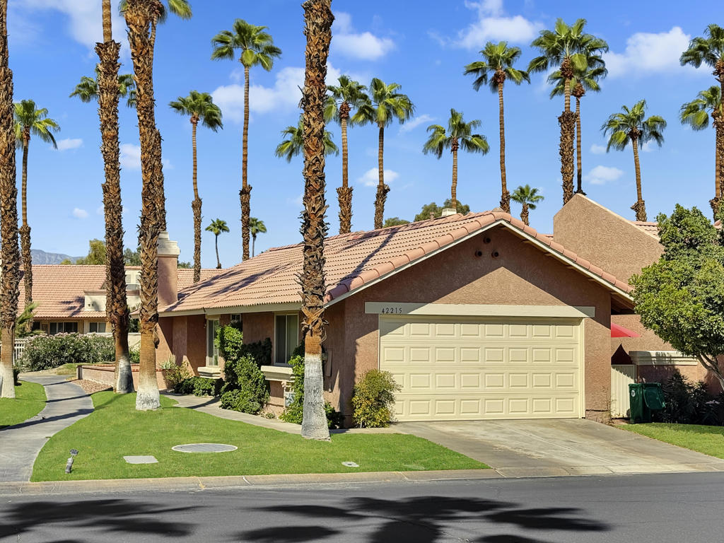 Spacious Oasis Country Club Home with wrap-around patio. Welcome to this light-filled single-level home in the sought-after Oasis Country Club! This rare property is attached on only one side, giving it a true sense of privacy. The massive living room is the heart of the home, featuring vaulted ceilings, a cozy fireplace, and an open-concept layout that seamlessly connects the dining area, breakfast bar, and kitchen. The kitchen is bright and airy with abundant counter space and cabinetry, perfect for cooking and entertaining. Offering three bedrooms (or two bedrooms plus a den/office), the flexible floor plan works for many lifestyles. The primary suite includes a private patio, en-suite bathroom, and generous closet space. The secondary bedroom boasts vaulted ceilings and direct access to the hall bath, while the third room is ideal as a guest space, office, or hobby room.Enjoy desert living at its finest on the expansive wrap-around covered patio, perfect for year-round outdoor dining, BBQs, and gatherings. A greenbelt and mature lemon tree sit just beyond your patio, providing a peaceful view. Additional highlights include newer dual-pane windows, a recently upgraded air conditioning system, and a newer hot water heater. Ceramic tile flooring runs through most of the home, creating a clean, low-maintenance look.Just steps from your door, you'll find one of the community's sparkling pools and spas. The Oasis Country Club offers a private 18-hole golf course, multiple pools and spas, tennis and pickleball courts, and even a putting course - all within a gated, beautifully landscaped community. Come see why so many love calling Oasis Country Club home!
