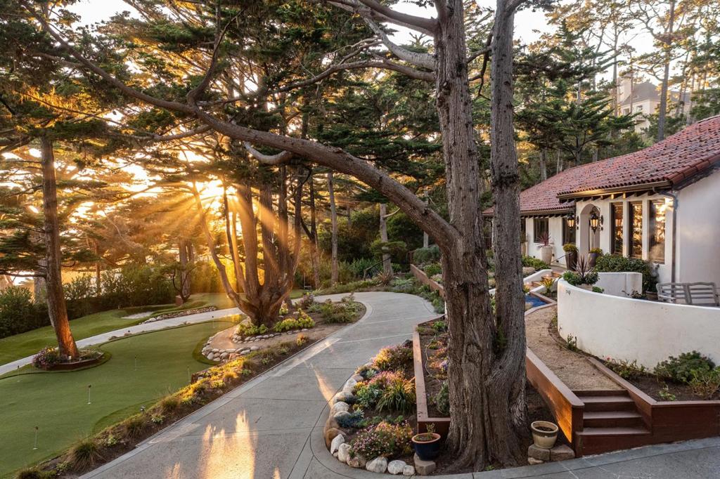 Experience the unmatched allure of Pebble Beach living in this beautifully renovated single-level Mediterranean home, located just steps away from the iconic Lone Cypress. Renovated in 2017, this residence features an array of unique design elements, including custom iron fixtures and artisanal tiles, all curated to create a refined yet relaxed atmosphere. The home boasts exposed beam cathedral ceilings, complemented by raw-edge wood elements that showcase masterful craftsmanship and an unwavering attention to detail. French doors seamlessly connect the indoor living areas to the outdoors, leading to two distinct patios, both offer stunning views of a putting green and chipping green and the ocean beyond providing the perfect setting for sunset gatherings and leisurely afternoons. This home features three spacious bedrooms and three bathrooms, with the option for a fourth bedroom or office, accommodating various lifestyle needs. Embrace the tranquility of this Mediterranean gem, where luxurious living meets the beauty of nature.