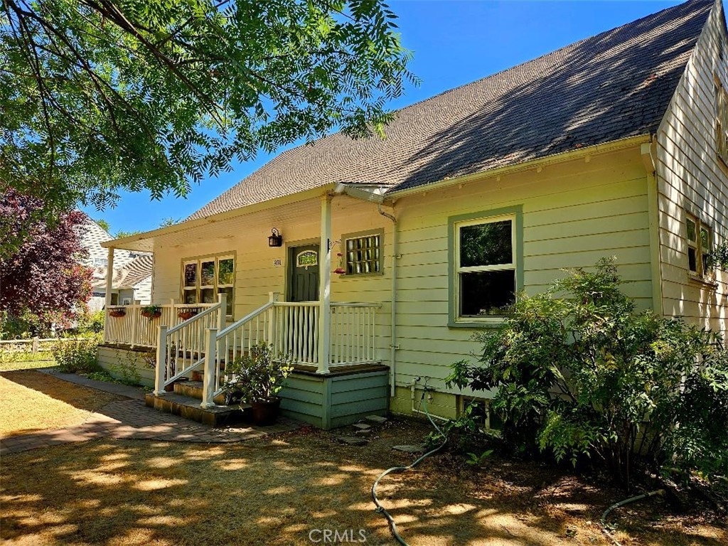 Welcome to this charming 3-bedroom, 2-bath home featuring a shady front porch perfect for morning coffee or evening relaxation. The spacious backyard includes a patio ideal for BBQs with family and friends, and the extra parcel provides ample space for play, gardening, or future expansion. Inside, you'll find a warm and inviting living/dining area with beautiful wood flooring. The generous kitchen sits near the rear entry with convenient access to the laundry area. Just off the front entry is a dedicated office space, plus a main-level bedroom and full bath perfect for guests or multi-generational living. Upstairs offers two additional bedrooms and a second full bath. A detached 2 car garage with alley access and a separate single car garage with extra workshop or storage space for tools and hobbies. With a little TLC, this property is full of potential and could be move-in ready in time for the holidays. Don't miss out, schedule your showing today and imagine the possibilities!