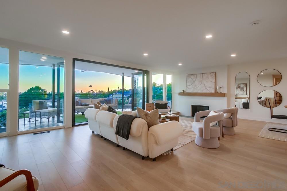 Welcome home to this stunning Mid-Century modern home that exudes all of the character and charm of the mid-century movement with panoramic views of the city. An entertainers dream from the moment you enter the custom white oak front door to the foyer and atrium, to the open concept living, kitchen and dining room complete with sunken fireplace and floor to ceiling windows and bifold doors to the large covered patio with sweeping sunset views to the west. Additional features include quartz counters, large peninsula with waterfall edge, primary suite with tons of natural light and views, dual shower heads, and designer tiles, secondary rooms with Jack and Jill bath, large family/bonus roof with fireplace, bar, and bifold doors opening to your spacious backyard, with covered patio and room for whatever you can dream! Houses with this much architectural beauty don't come around often. Don't miss this one!
