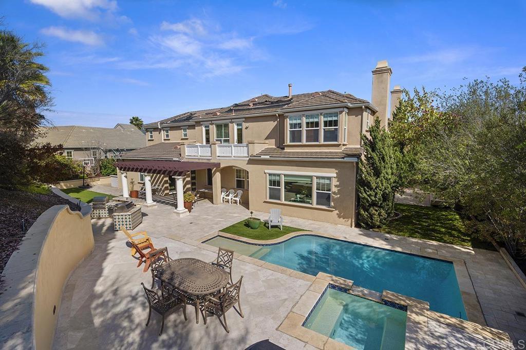 Welcome to your forever home, nestled in the prestigious and highly desirable community of The Woods in Eastlake. This stunning estate offers over 6,200 square feet of thoughtfully designed living space, with six spacious bedrooms and six and a half bathrooms. From the moment you step through the front door, you’re welcomed by soaring coffered ceilings, wood and travertine floors, and a dramatic circular staircase with wrought iron. The gourmet kitchen is a true showstopper, complete with granite countertops, cherry wood cabinetry, stainless steel appliances, and ample space to cook, entertain, and gather with the people who matter most. The home’s spacious floor plan flows effortlessly into a spacious family room, where one of four fireplaces creates a warm and inviting ambiance. Step outside and you’ll find your own private retreat. A sparkling pool, relaxing spa, built-in BBQ, and a side patio designed for entertaining or simply unwinding under the stars. With paid-off solar panels and two powerful AC units, you can enjoy year-round comfort without worrying about the energy bill. There’s plenty of space for everyone here, including a private downstairs suite with its own full bath and separate outdoor entrance; ideal for guests, extended family, or even a casita-style setup. Two bedrooms are conveniently located downstairs, while the rest of the home offers a perfect mix of wood, tile, and carpeted flooring. The details throughout speak volumes—crown molding, wainscoting, custom built-ins, and an elegant entry medallion that adds a touch of grandeur. A spacious four-car garage provides all the storage you could ask for, and access to The Woods Clubhouse rounds out the community lifestyle, all with a low HOA.
