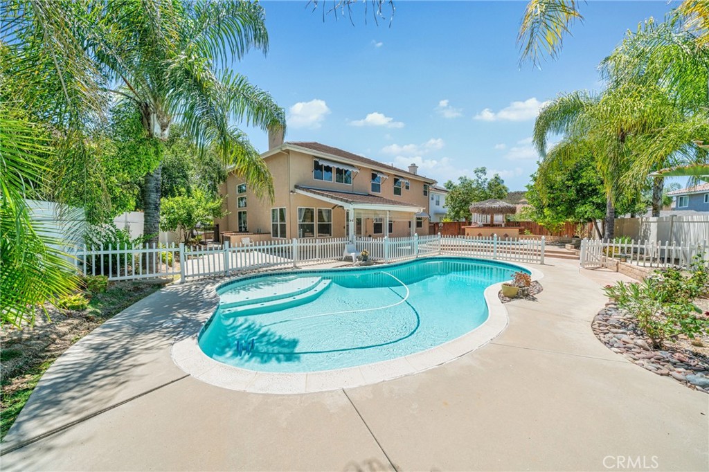 Welcome to 39647 Dartanian Place, a refined residence nestled in a peaceful and mature neighborhood of Murrieta.
This home masterfully balances multi-generational living needs with the modern desire for space, comfort, and elevated lifestyle - a truly ideal place to call home.
The layout is thoughtfully designed with dual primary suites located on both levels, offering exceptional privacy and convenience for extended families or guests.
An additional bonus room upstairs provides versatile space for a sixth bedroom, media room, gym, or home office - adaptable to any lifestyle.
The soaring ceilings in the living room invite abundant natural light, creating an open and airy atmosphere.
While the kitchen flows seamlessly into the family room for everyday living, it maintains a clean and functional design, ready to be personalized to your taste.
Step outside to your private backyard retreat, where a fully finished pool, built-in BBQ island, and outdoor refrigerator/prep station create an ideal setting for summer gatherings or tranquil evenings.
Surrounded by lush greenery and designed with privacy in mind, this outdoor space delivers a resort-style living experience at home.
Additional highlights include a three-car attached garage, a wide driveway, and a prime location close to top-rated schools, parks, shopping centers, and major commuter routes.
This is not just a home - it’s a harmonious blend of thoughtful architecture, everyday practicality, and lifestyle-driven amenities.
Schedule your private tour today and experience the exceptional value of 39647 Dartanian Place.