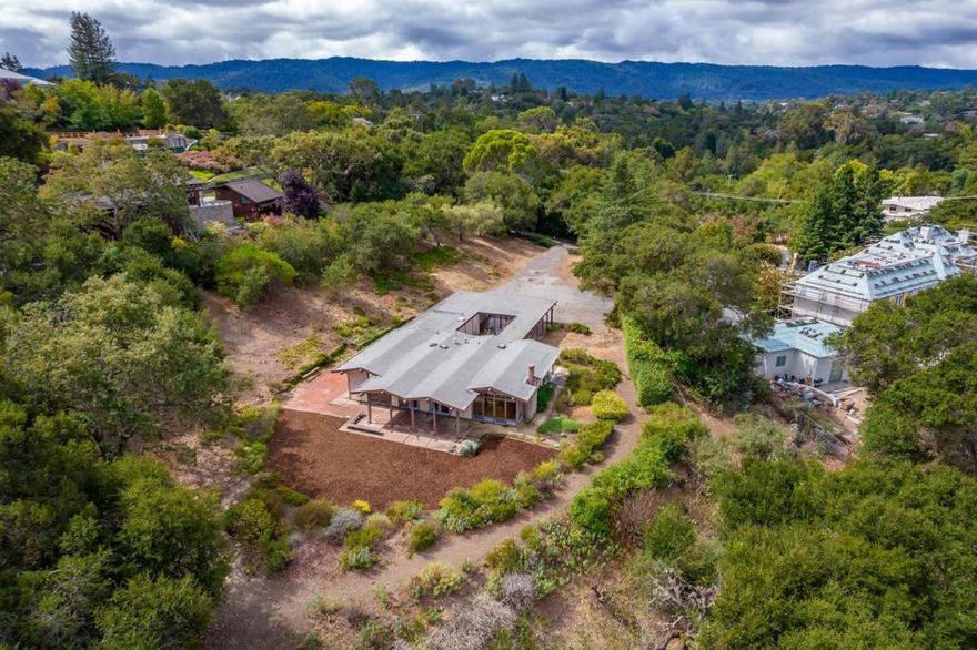 In highly sought-after west Atherton, this mid-century modern home presents an excellent opportunity for development of a dream estate. Situated on a slightly elevated 1.10-acre lot with mature landscaping that provides privacy, the property offers expansive, level space with a gently sloping perimeter on the eastern edge. The site offers stunning views of the East Bay hills as well as glimpses of the San Francisco Bay, which would be further enhanced from a second story on a new estate home. The existing home is a 1,950-square-foot, single-level residence with 4 bedrooms and 2 baths. The property is located within the prestigious Las Lomitas School District and is just minutes from Stanford University, Silicon Valley tech and venture capital hubs, and conveniently positioned between two international airports. This is a rare opportunity in a prime location, perfect for creating a dream estate.